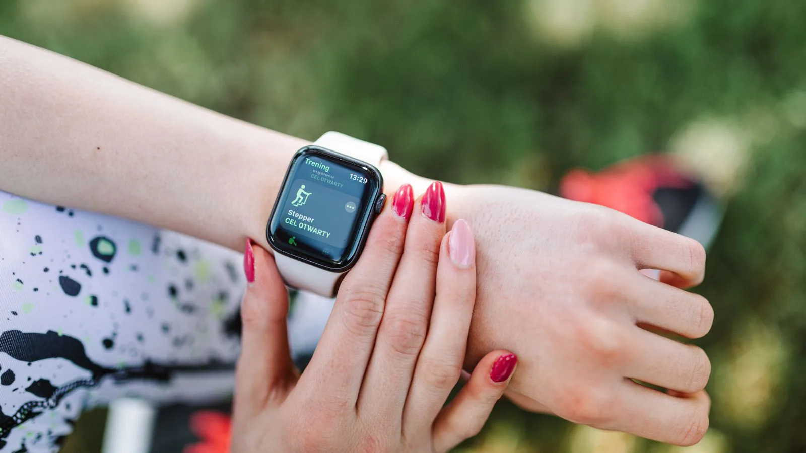 A fitness smartwatch on a wrist during exercise.