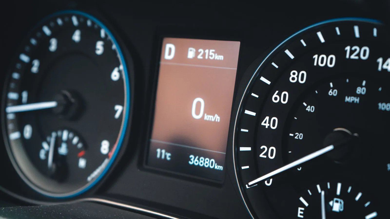 A car dashboard showing the speedometer and the odometer.