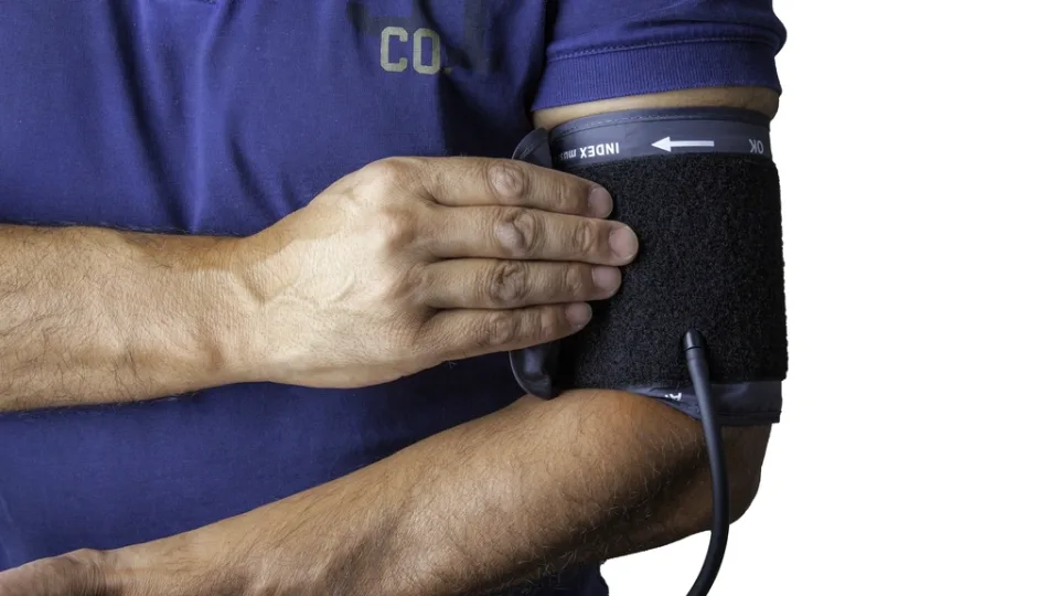 A blood pressure cuff wrapped around a bare upper arm.