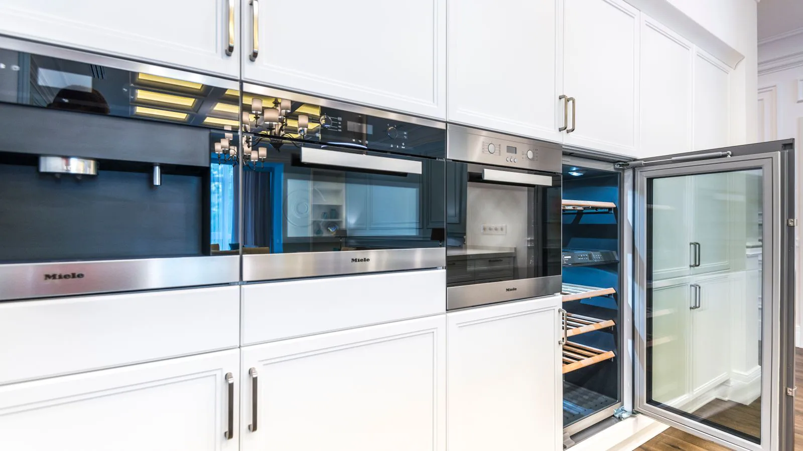 A contemporary kitchen with built-in oven and appliances.