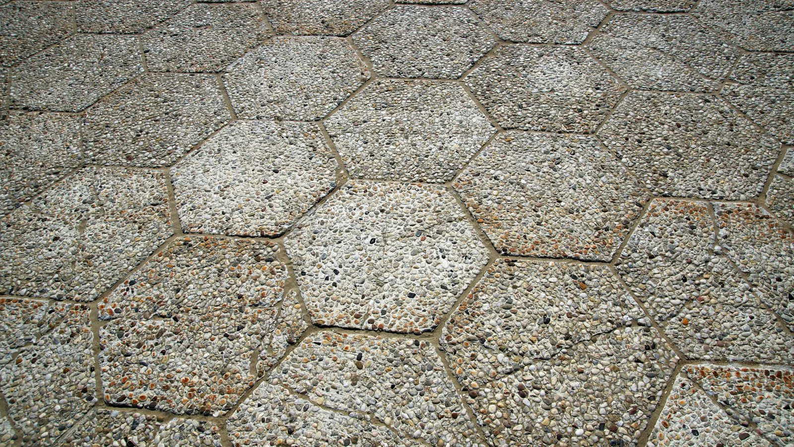 Hexagonal stone paving seen from above.