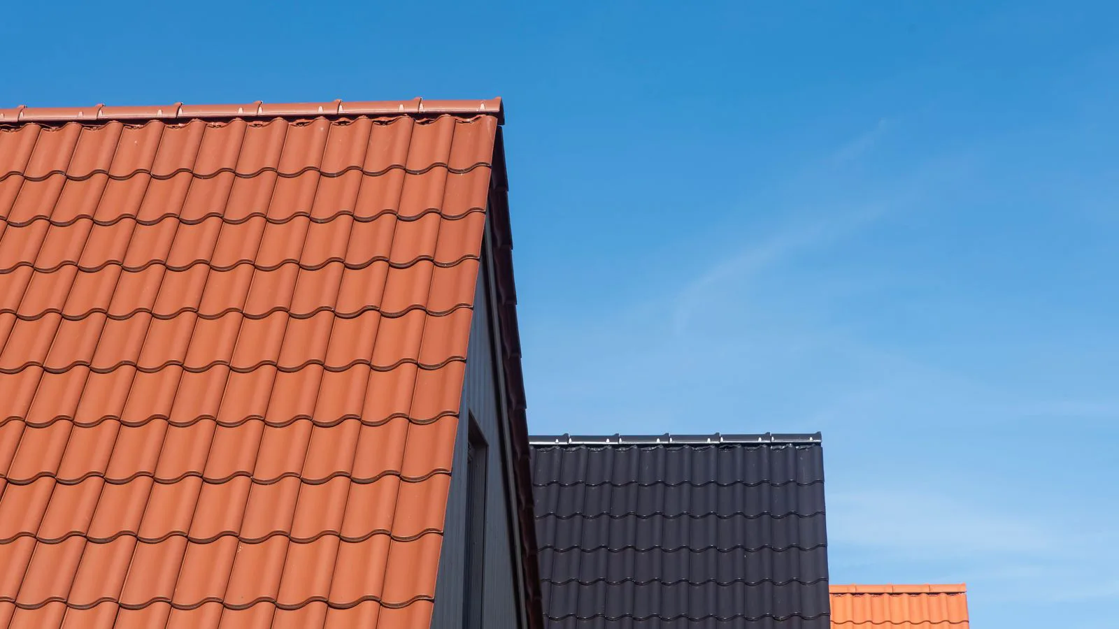 Tiled rooftops against a clear blue sky.