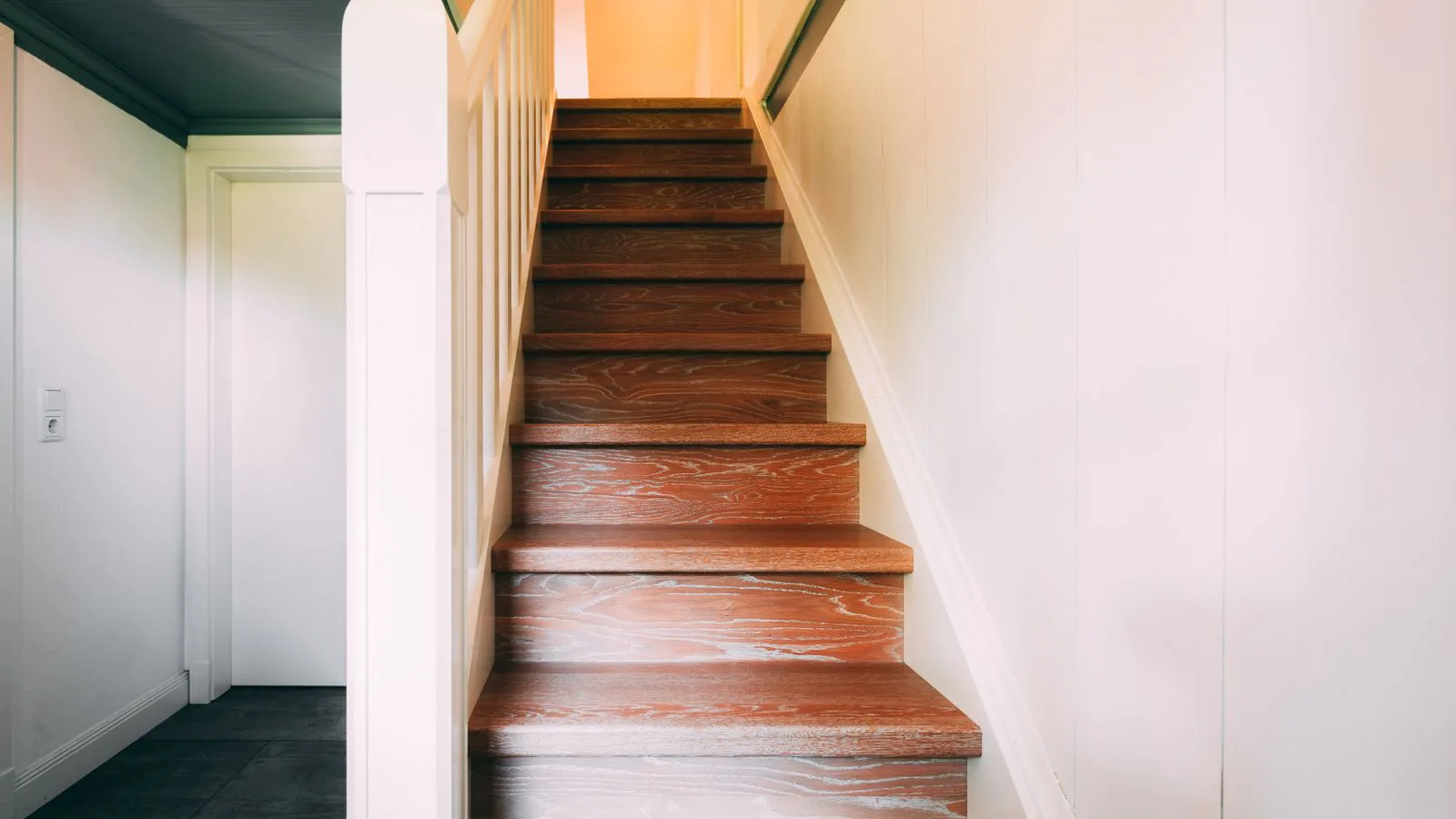 A wooden staircase rising to the floor above.
