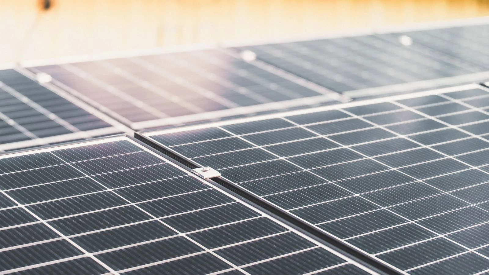 A rooftop array of solar panels in sunlight.