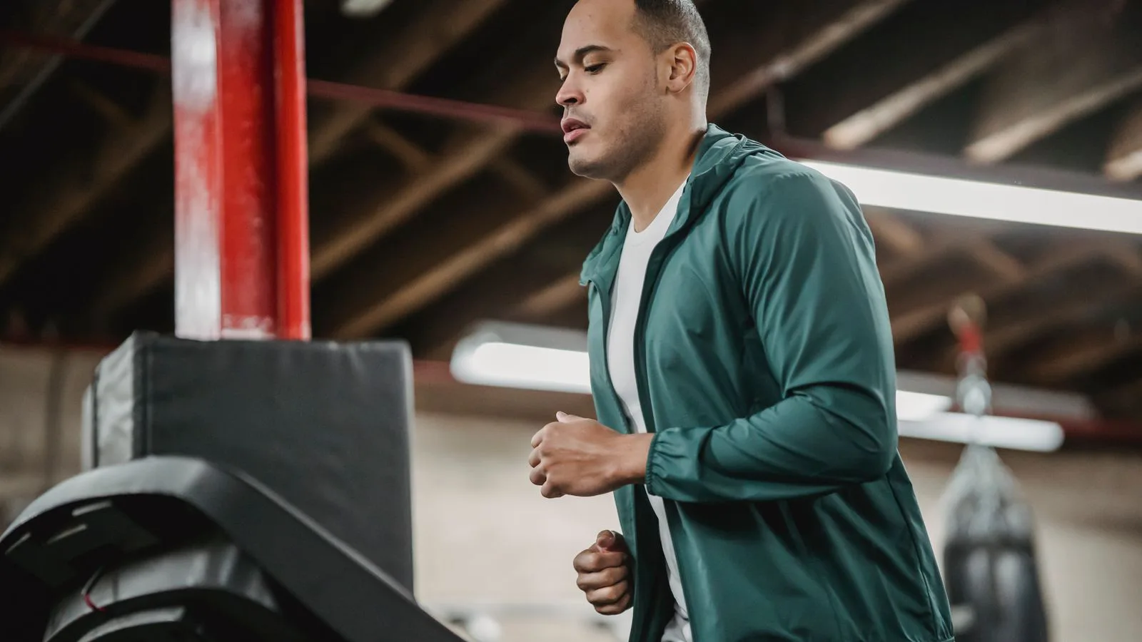 A man jogging indoors, seen from the side.