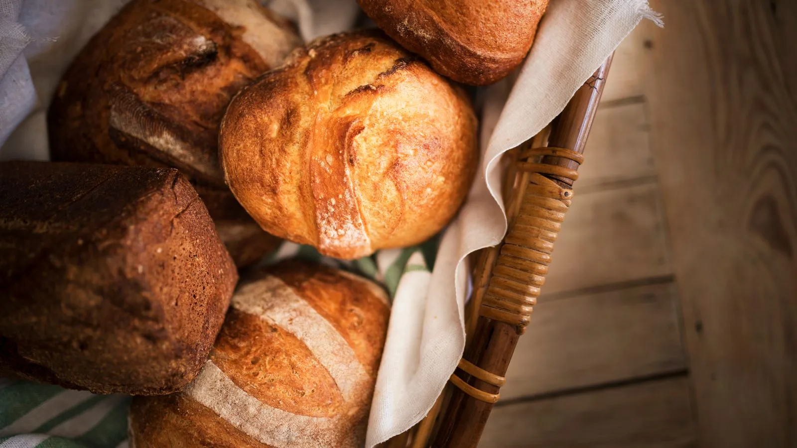 Freshly baked sourdough loaves and rolls, seen from above.