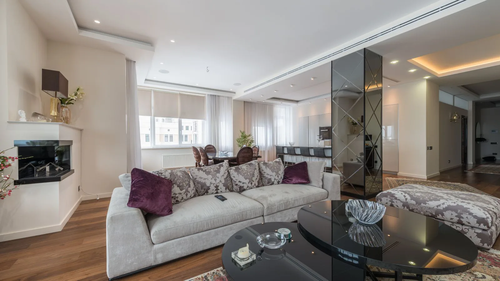 A furnished living room with a sofa, low table and daylight.