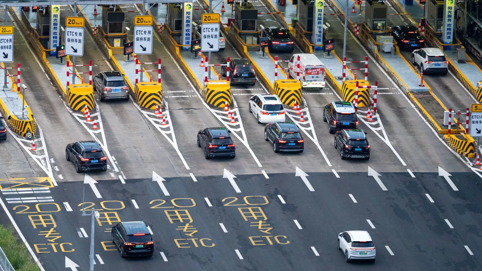 A busy motorway toll plaza seen from above.