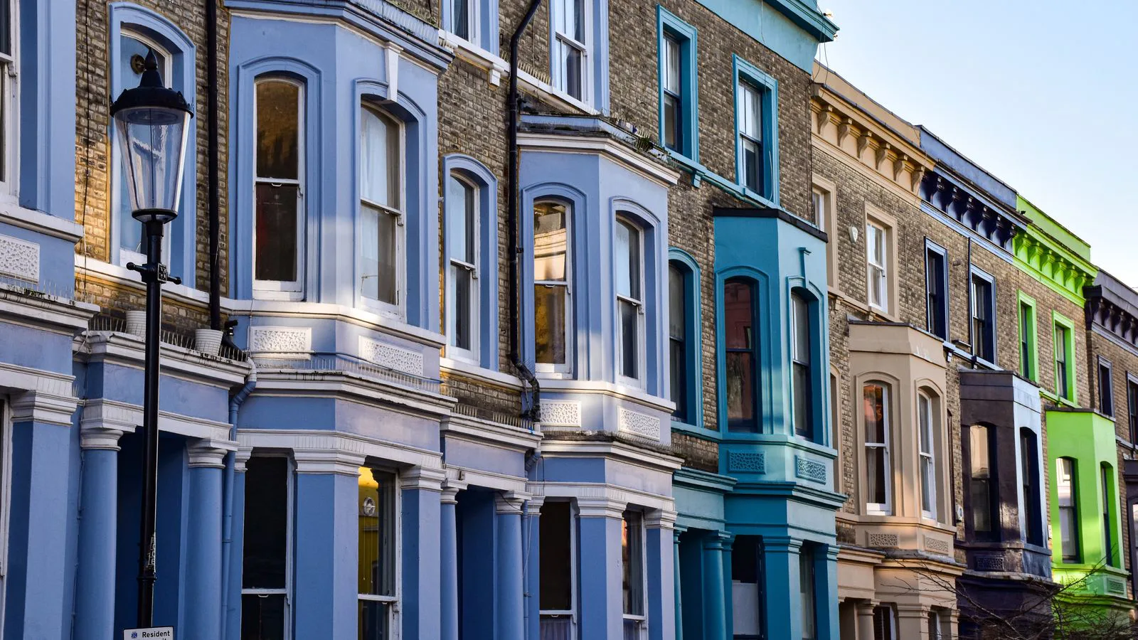 A row of brightly painted Victorian townhouses in London.