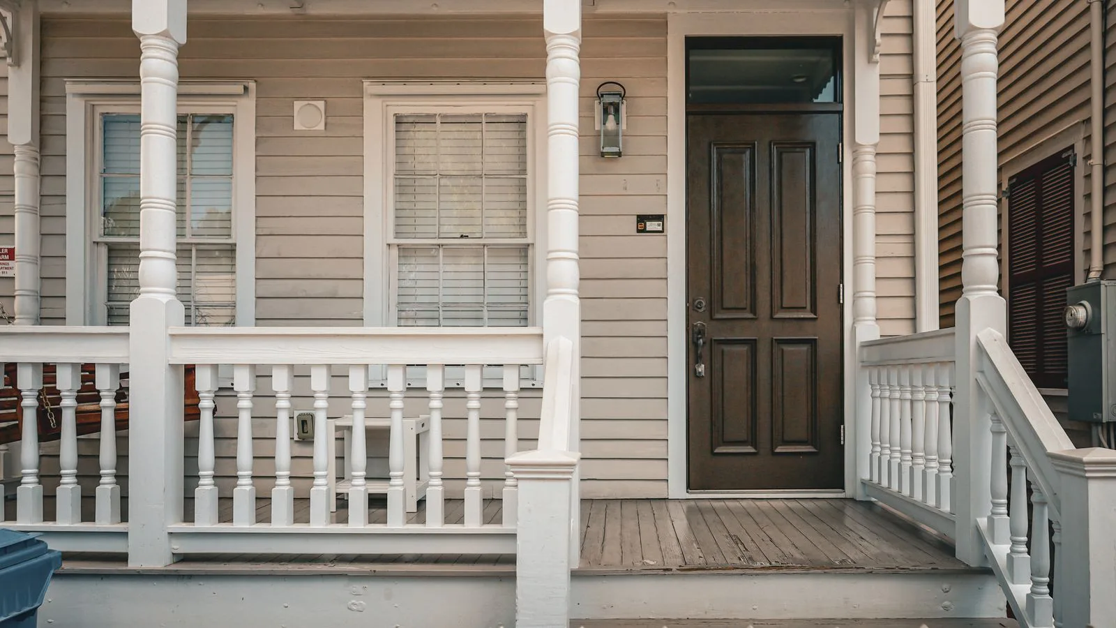 The porch and front door of a timber house.