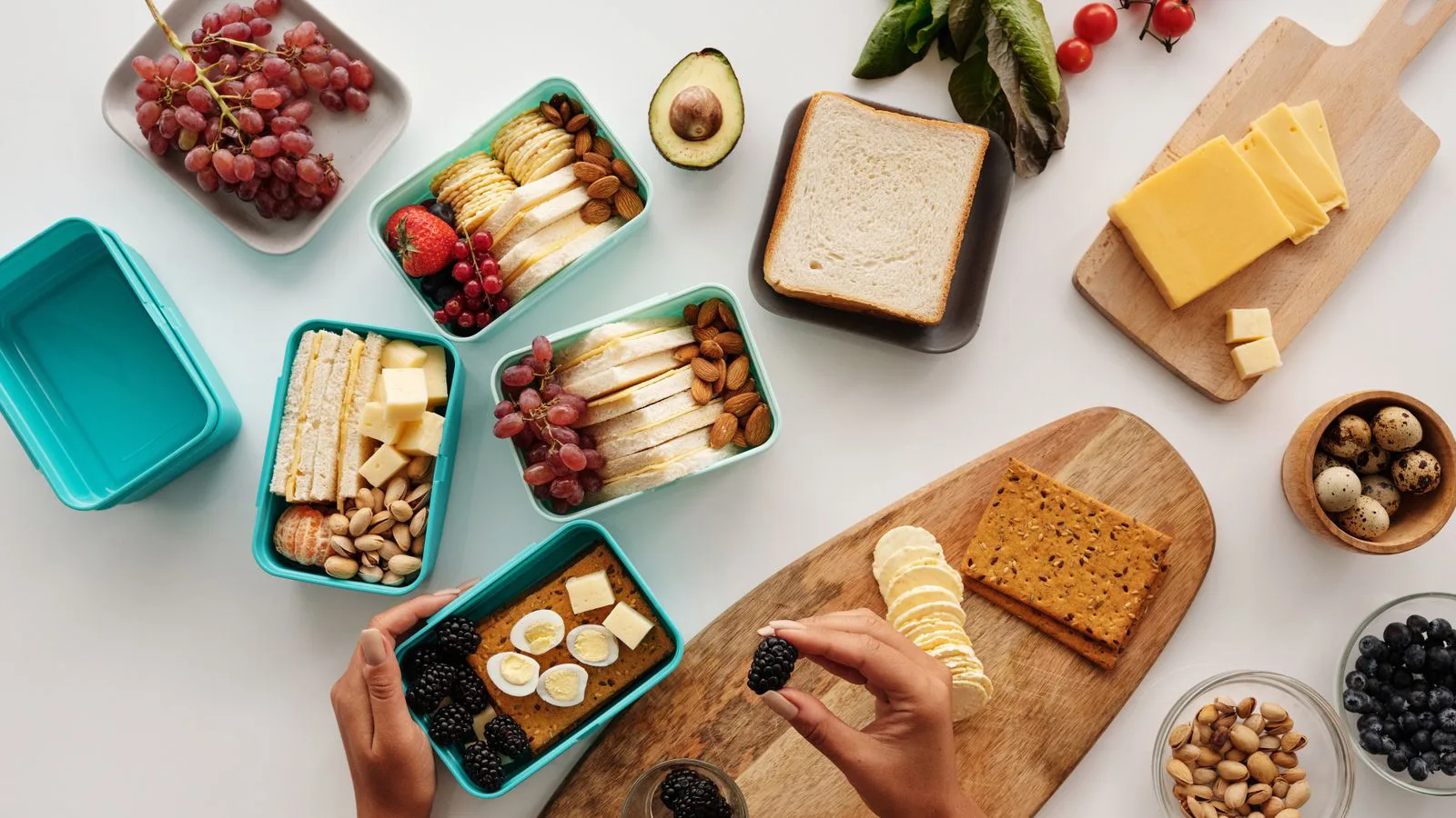 Prepared meals laid out in containers, seen from above.