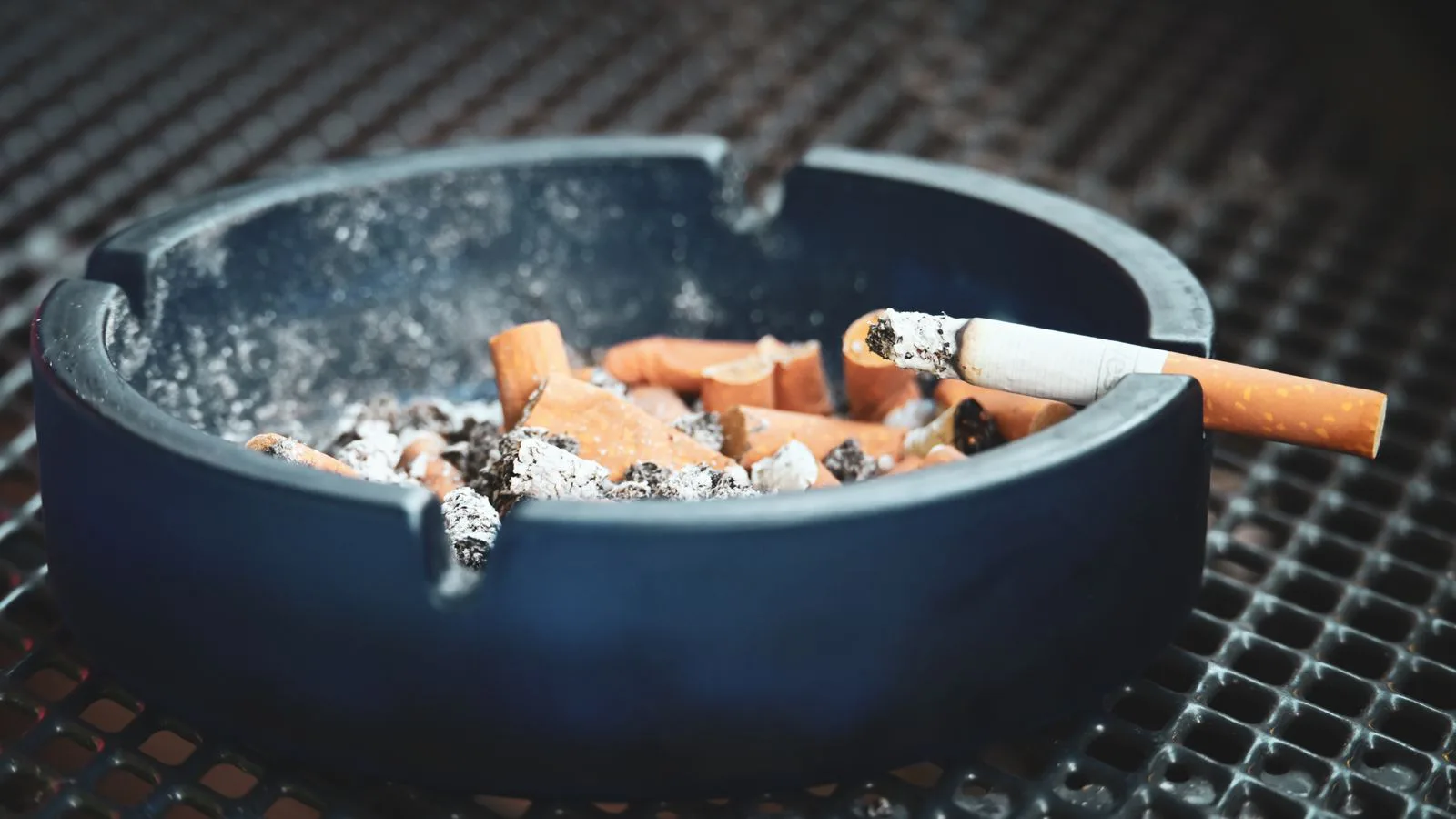 Cigarette ends and ash in an ashtray.