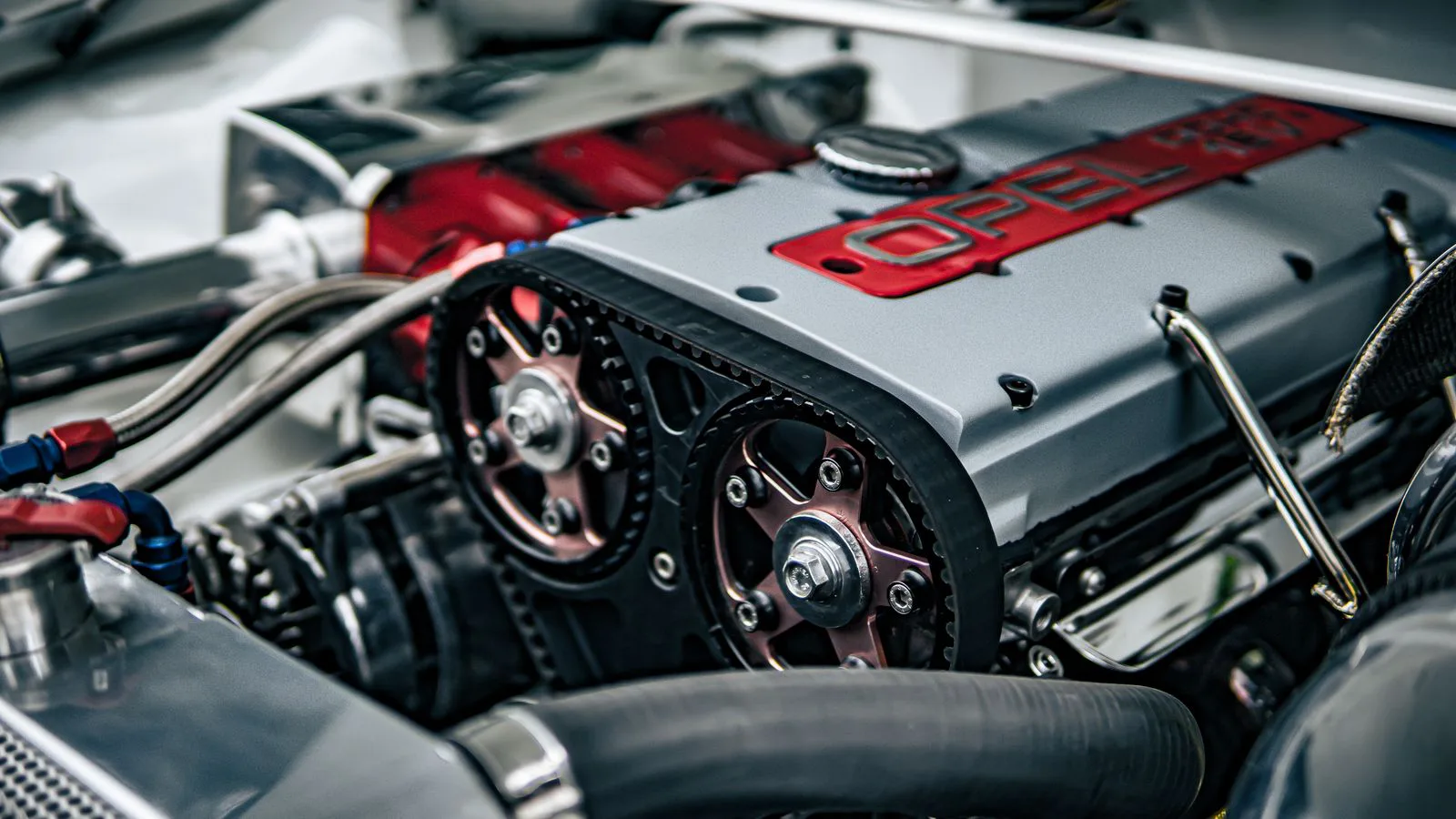 An open engine bay with the block, belts and hoses in view.